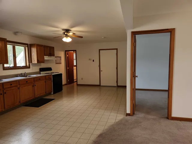 a view of a kitchen with a sink and a stove top oven
