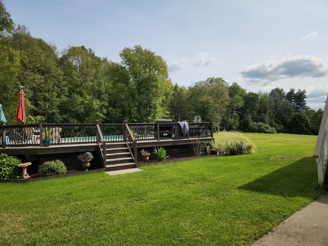 a view of a house with a backyard