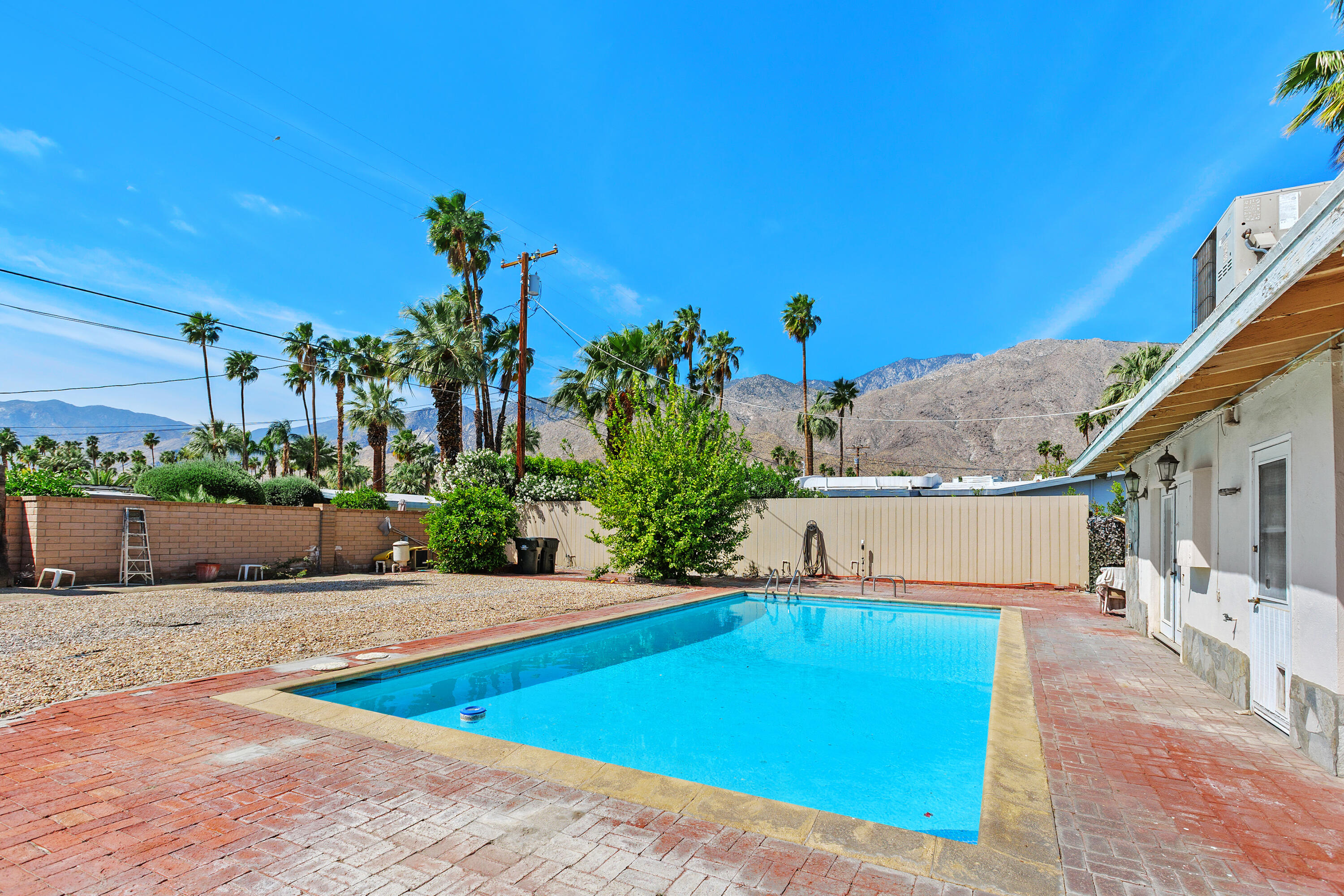 1077 South Riverside Drive Palm Springs, CA 92264 - Photo 31 of 35 a view of a house with a swimming pool
