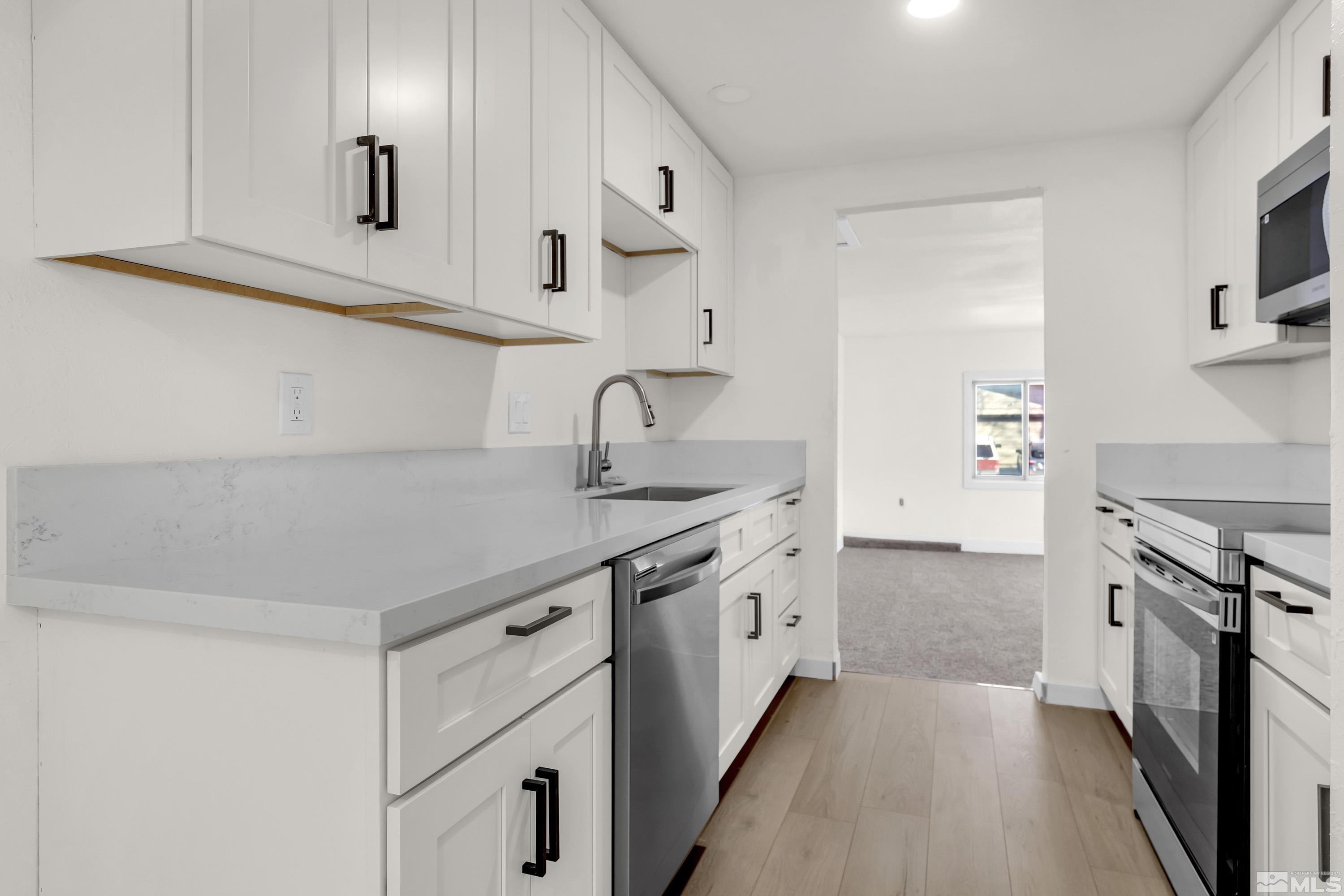 1349 Butler Street Reno, NV 89512 - Photo 1 of 36 a kitchen with stainless steel appliances granite countertop a sink stove and refrigerator