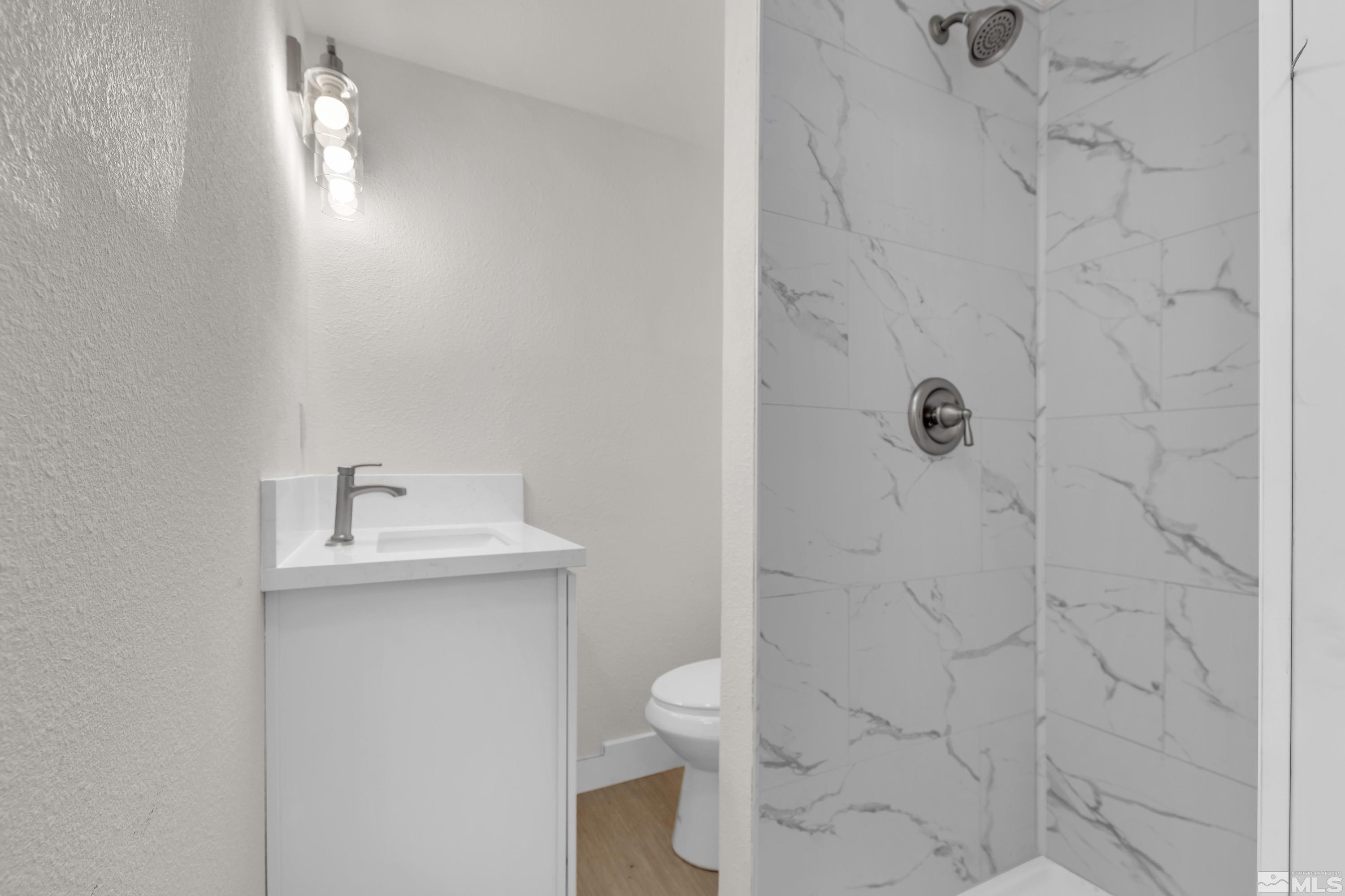 1349 Butler Street Reno, NV 89512 - Photo 18 of 36 a bathroom with a toilet a sink and shower