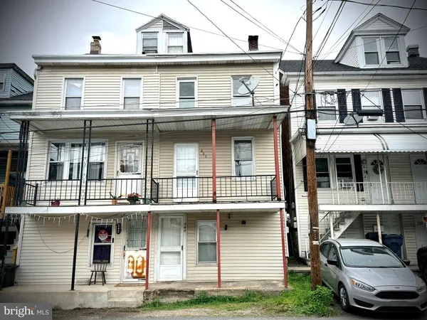 a view of a white building with large windows