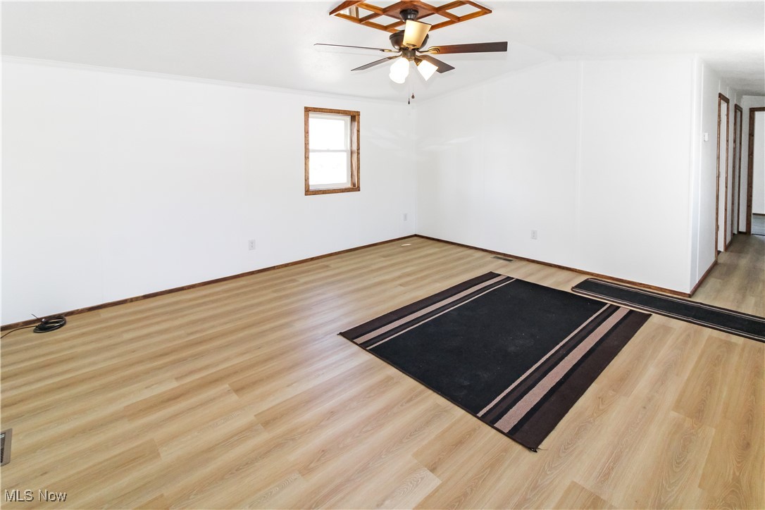 265 Meachem Road, Unit 41 Port Clinton, OH 43452 - Photo 9 of 33 Empty room with a ceiling fan and wood finished floors