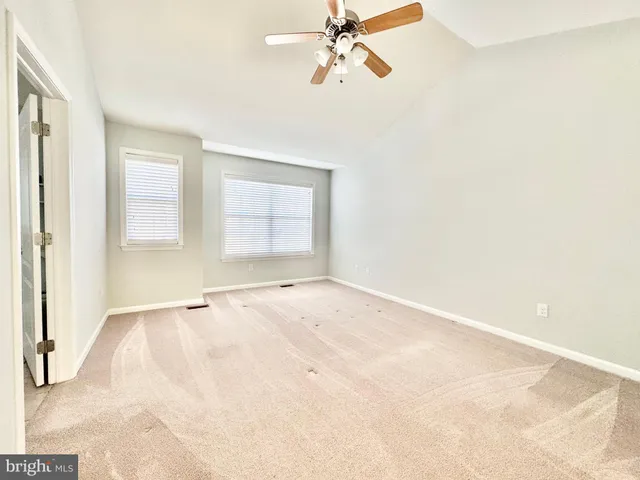 a view of a livingroom with a ceiling fan and window