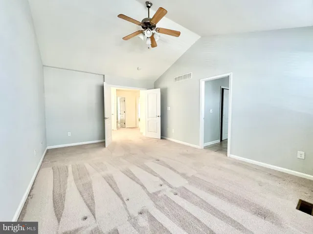 a spacious bathroom with a granite countertop sink mirror and a