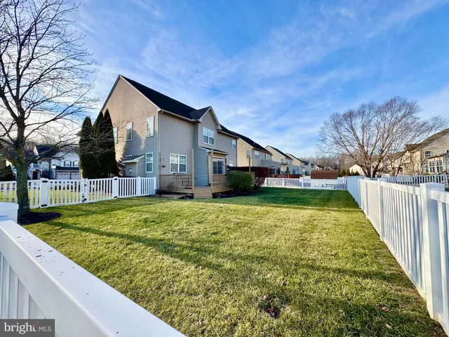 a house view with swimming pool in front of it