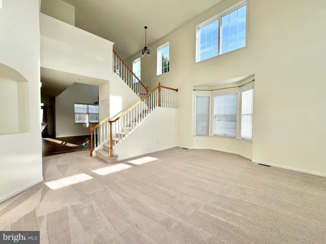 a view of an empty room with stairs