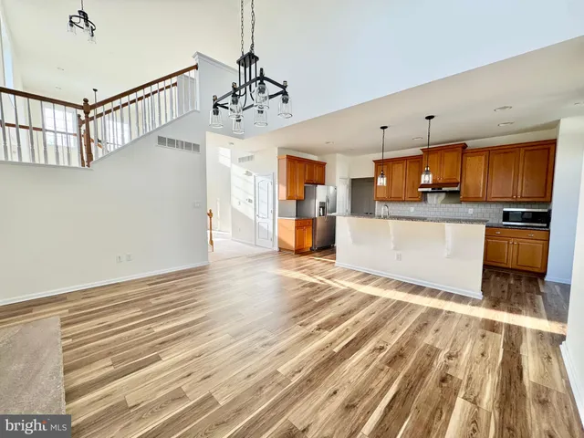 a view of a kitchen with a stove cabinets and a wooden floor