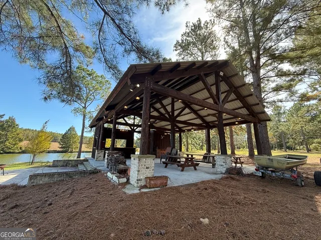 a backyard of a house with table and chairs
