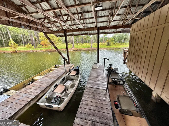 a open kitchen with stainless steel appliances granite countertop a refrigerator a sink dishwasher a stove and white countertops with wooden floor