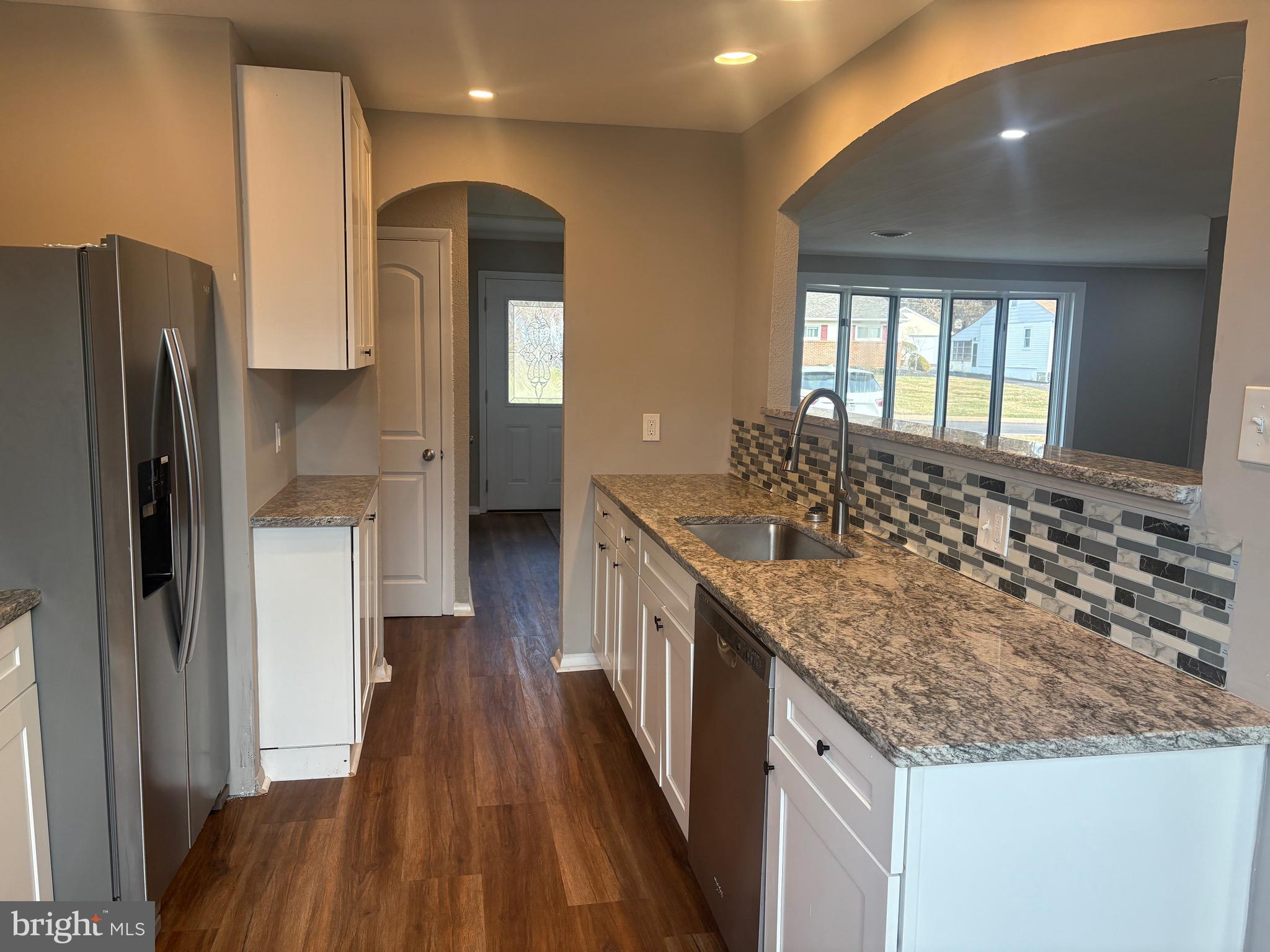932 Rozel Avenue Southampton, PA 18966 - Photo 13 of 32 a bathroom with a granite countertop sink a refrigerator and a mirror