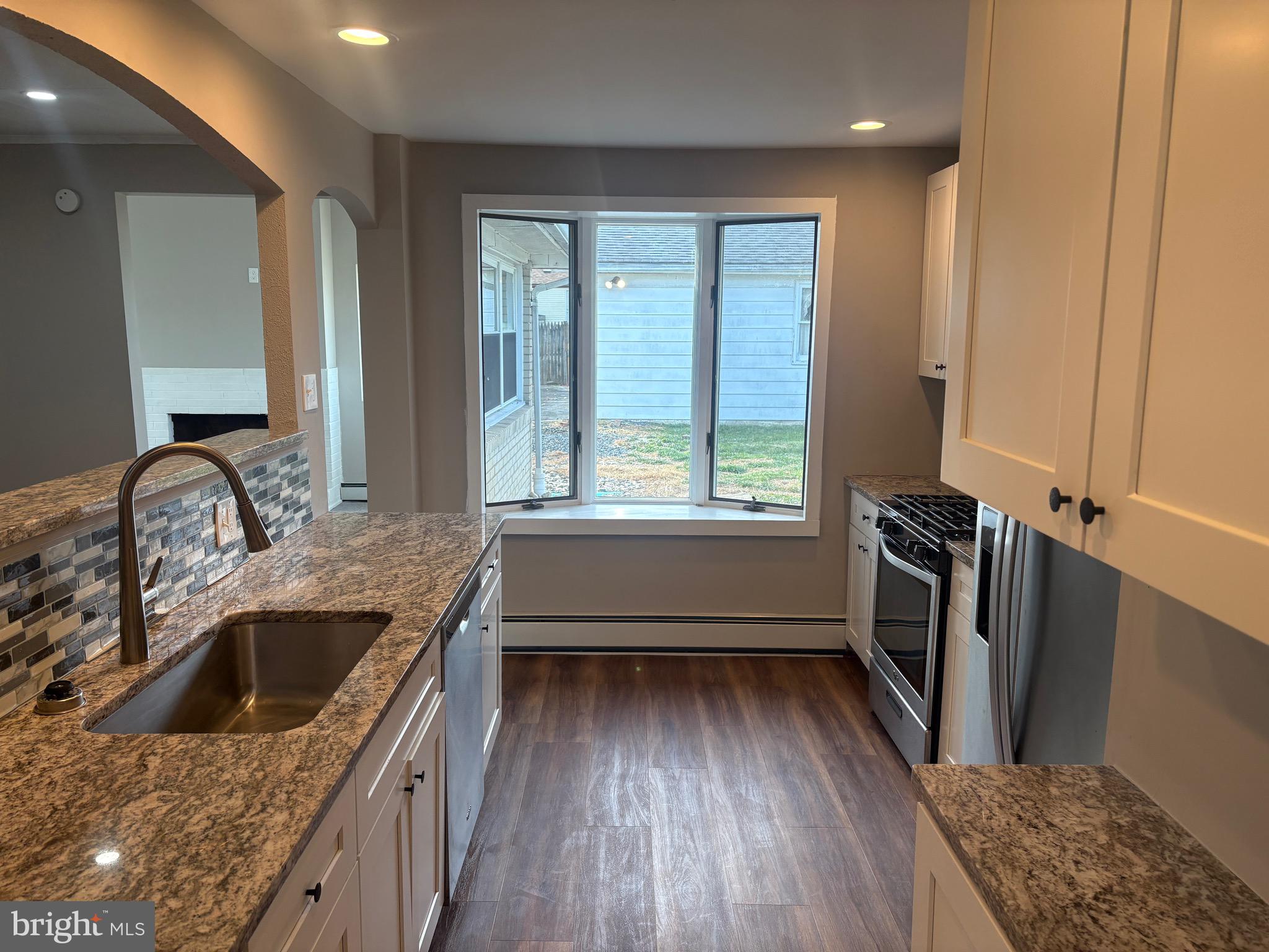 932 Rozel Avenue Southampton, PA 18966 - Photo 14 of 32 a kitchen with a wooden floor sink stove and refrigerator