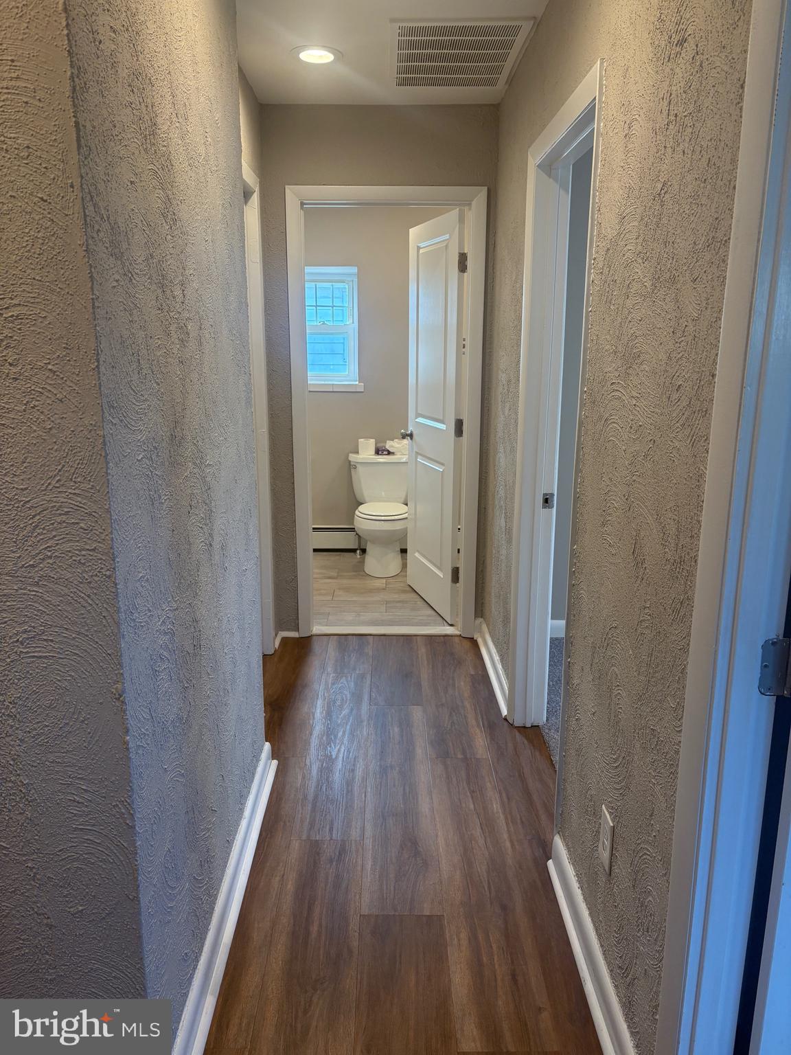 932 Rozel Avenue Southampton, PA 18966 - Photo 26 of 32 a view of a hallway with wooden floor and a bathroom