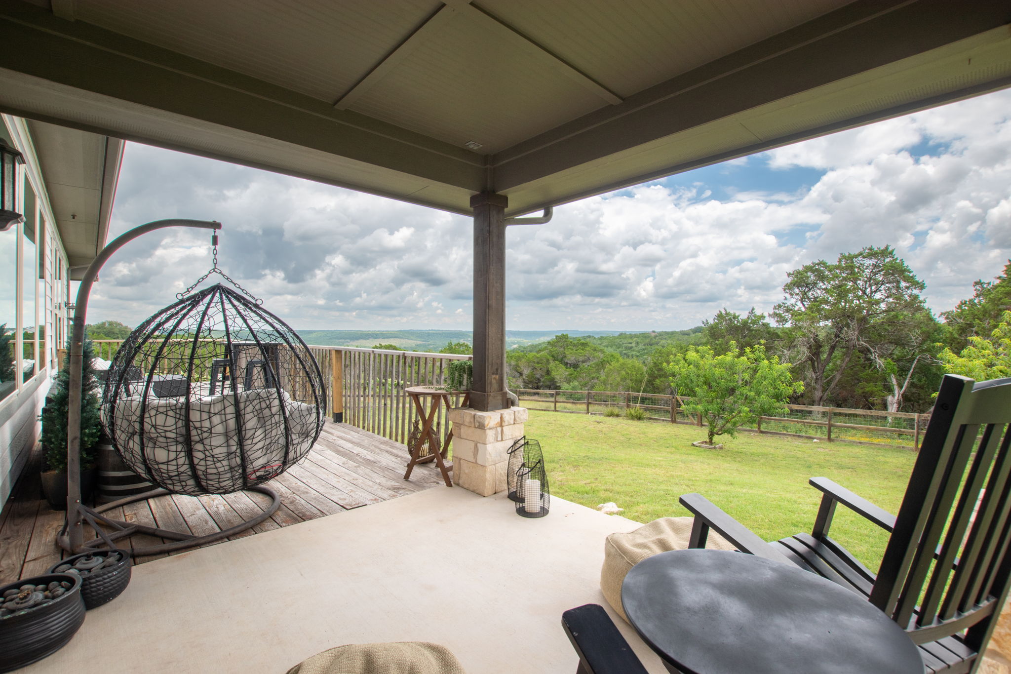 155 Balcones Ridge Way Bertram, TX 78605 - Photo 6 of 37 The inviting covered patio and deck reveal sweeping views of the surrounding natural landscape.