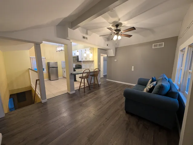 a living room with furniture and a chandelier