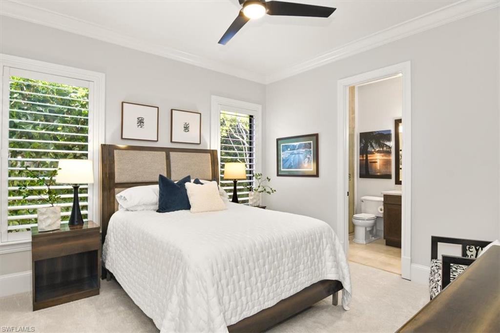 2220 Residence Circle Naples, FL 34105 - Photo 22 of 50 a bedroom with a large bed and a window