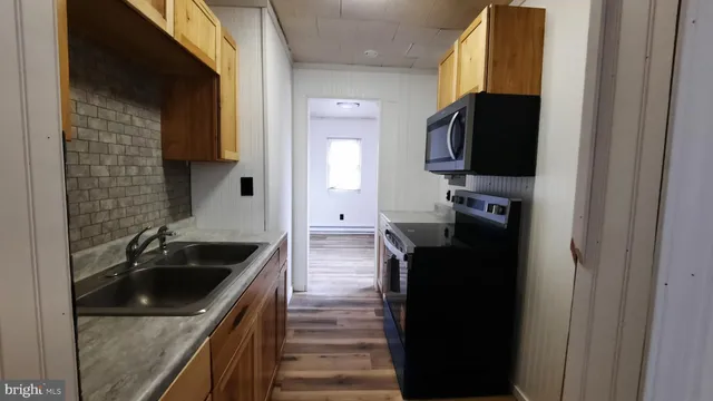 a kitchen with a sink stove and refrigerator