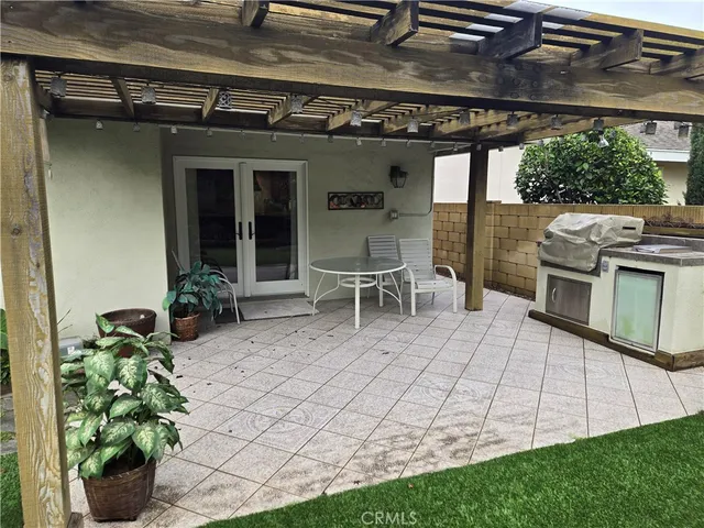 a view of a patio with table and chairs and potted plants