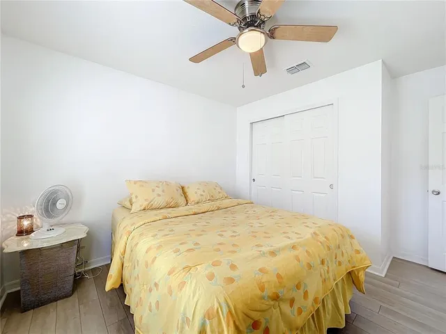 a bedroom with a bed and wooden floor