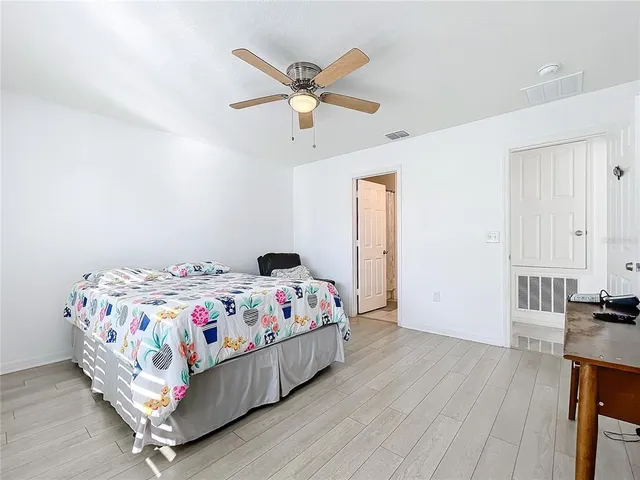 a bedroom with a bed and a tv