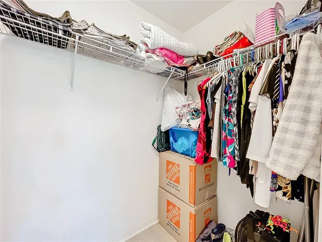 a view of walk in closet with clothes