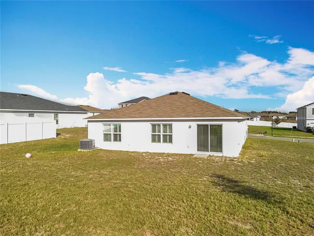 a view of a house with pool and a yard