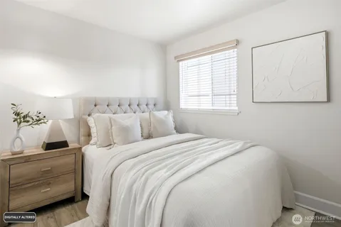 a bedroom with a large bed and a window