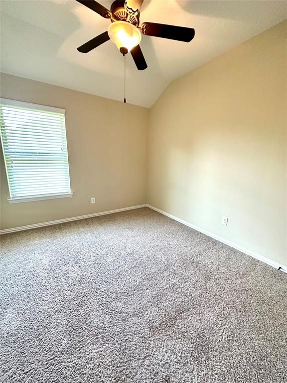 14818 Raleigh's Meadow Court Cypress, TX 77433 - Photo 11 of 17 an empty room with a window and a ceiling fan