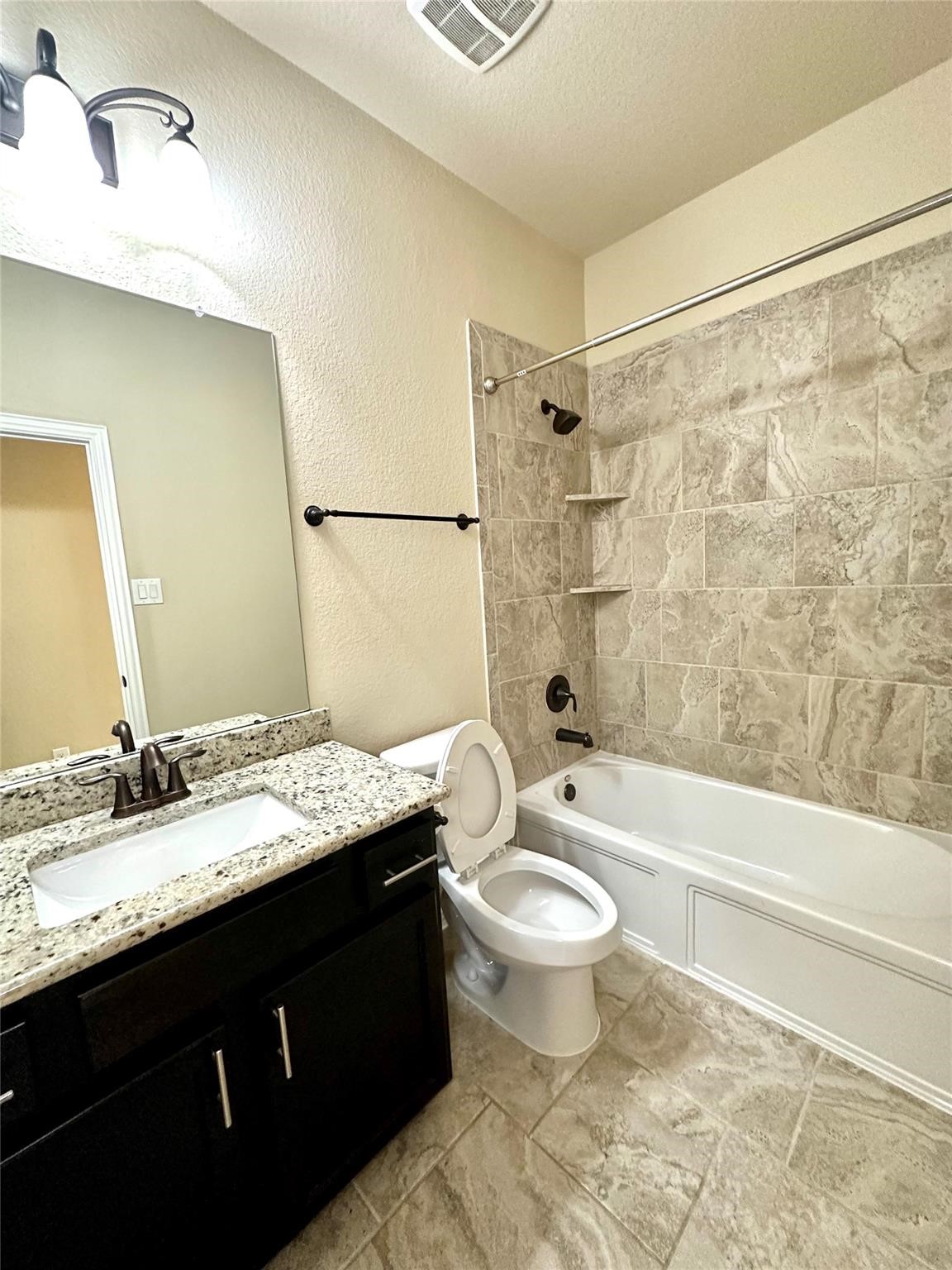 14818 Raleigh's Meadow Court Cypress, TX 77433 - Photo 8 of 17 a bathroom with a granite countertop sink toilet and shower