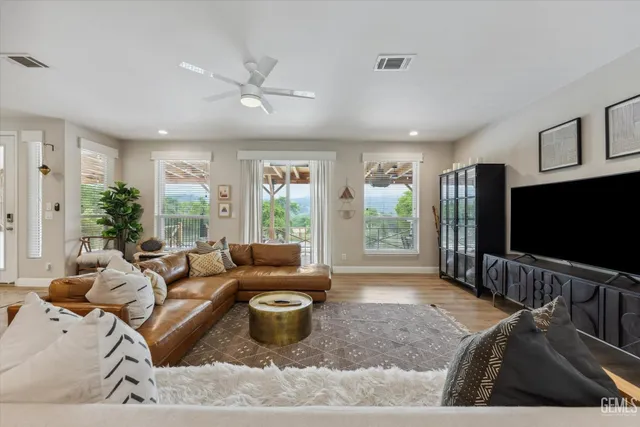 a living room with furniture and wooden floor