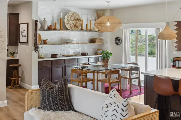 a view of a dining room and livingroom with furniture wooden floor and a rug