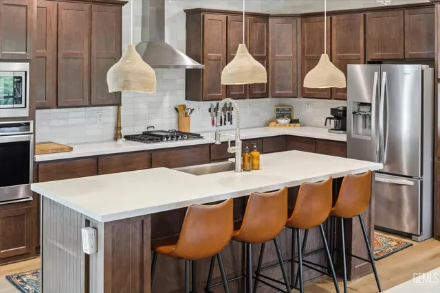 a kitchen with a sink stove and refrigerator