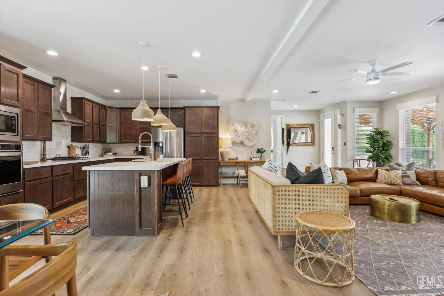 Undisclosed Address Keene, CA 93531 - Photo 21 of 60 a living room with stainless steel appliances kitchen island granite countertop a table chairs and a refrigerator