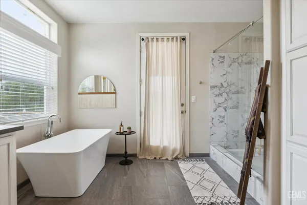 a bathroom with a bathtub and shower