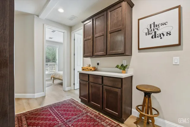 a bedroom with a large bed and a chandelier