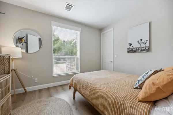 a bathroom with a sink a toilet a shower and a mirror