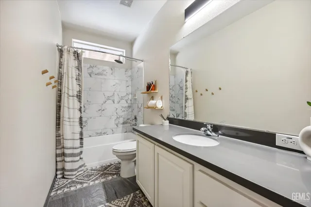 a bathroom with a toilet mirror and sink