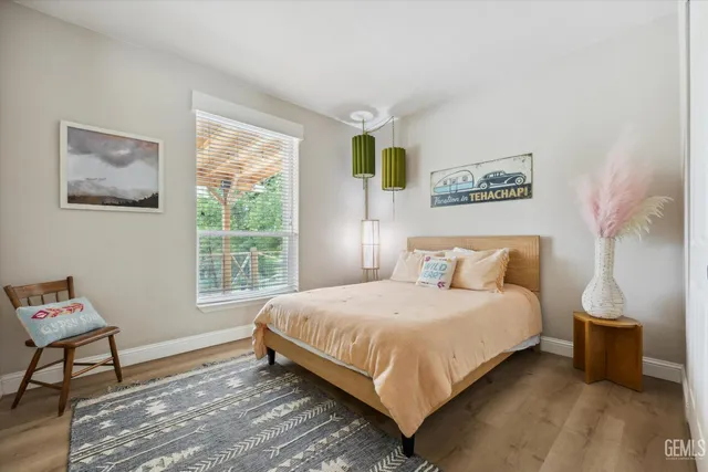 a bedroom with two beds and a wooden floor