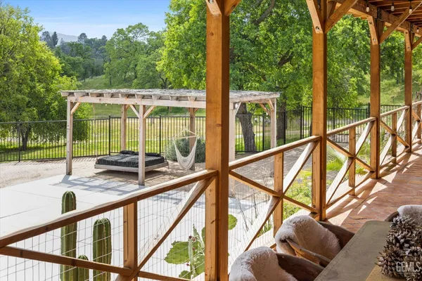 a view of a patio with couches chairs with wooden floor