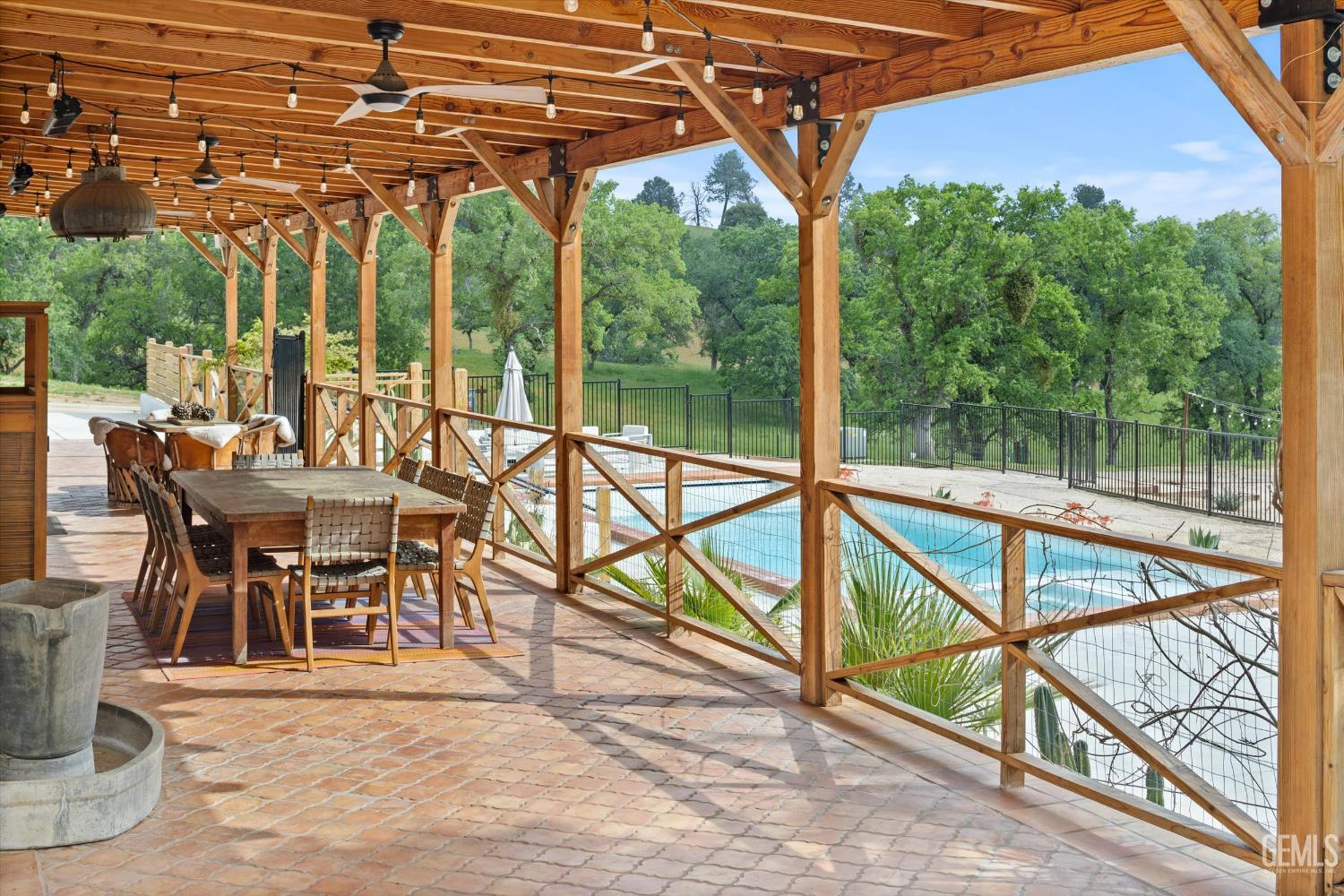 Undisclosed Address Keene, CA 93531 - Photo 5 of 60 a view of a patio with a table and chairs under an umbrella