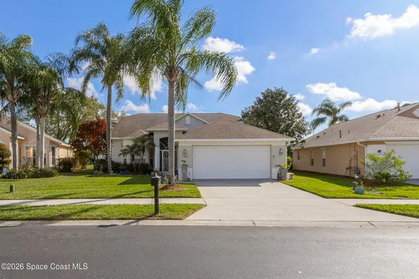 a house with palm tree in front of it