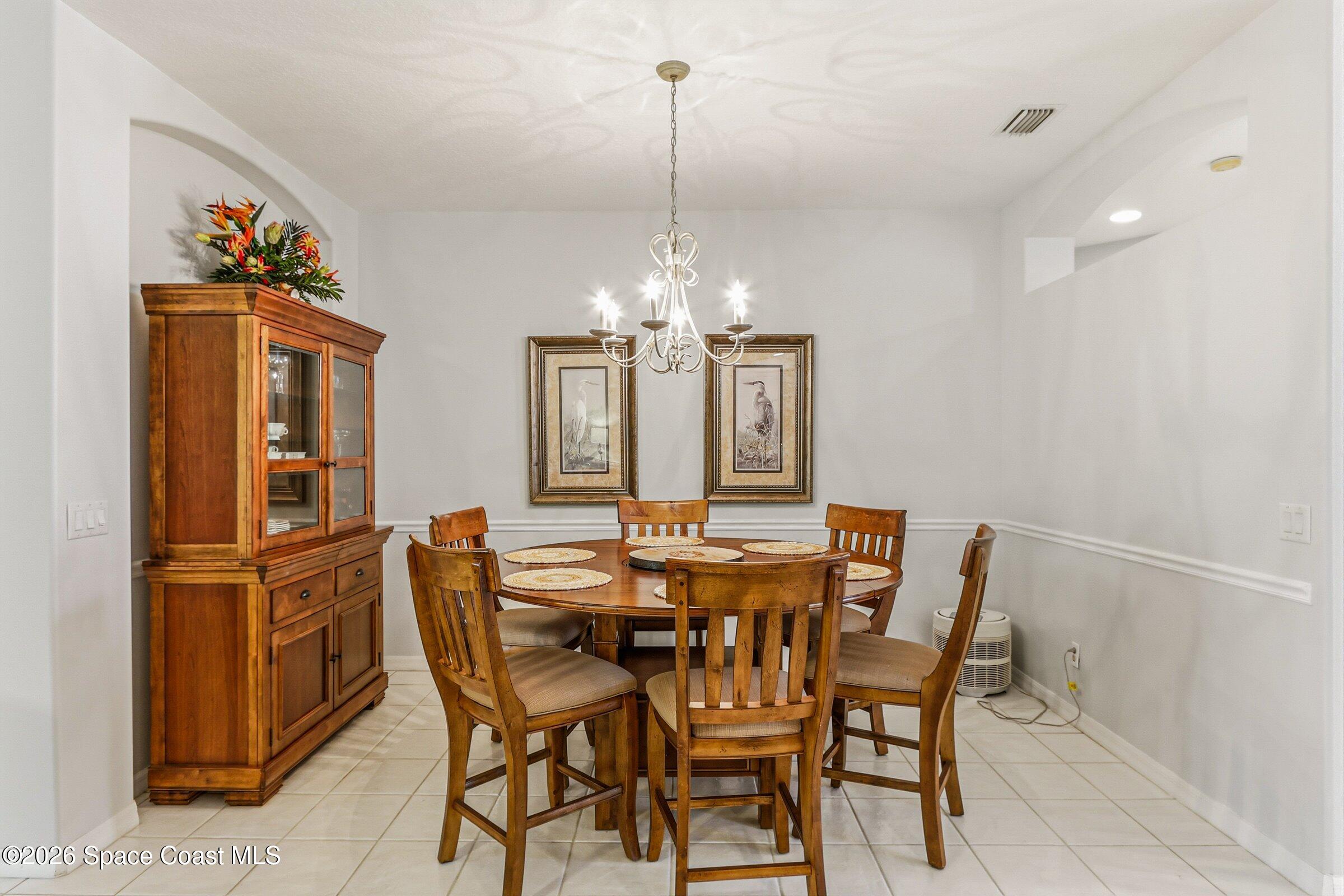 1825 Ficus Point Drive Melbourne, FL 32940 - Photo 13 of 48 a view of a dining room with furniture and chandelier