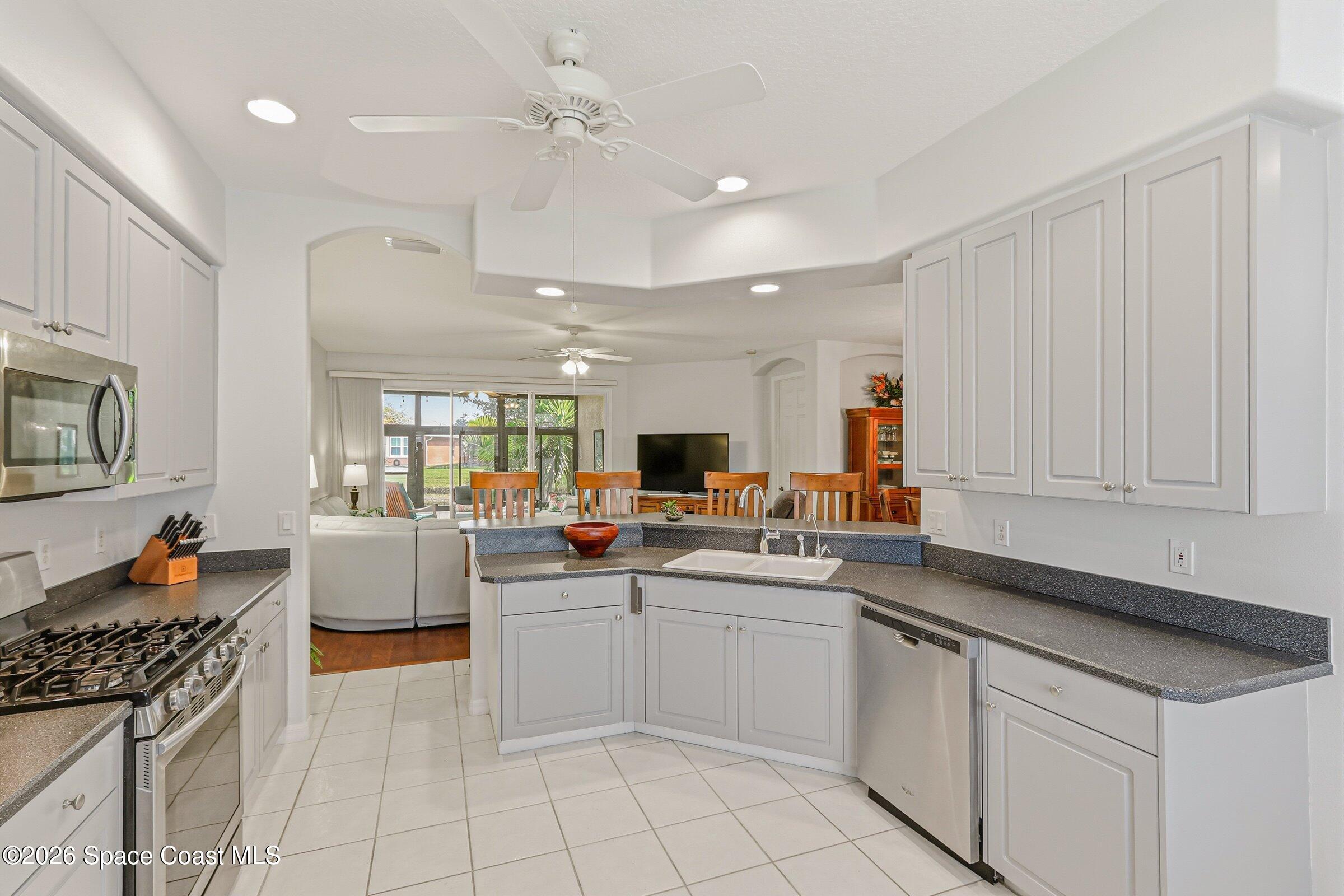 1825 Ficus Point Drive Melbourne, FL 32940 - Photo 47 of 48 a kitchen with stainless steel appliances granite countertop a sink and cabinets