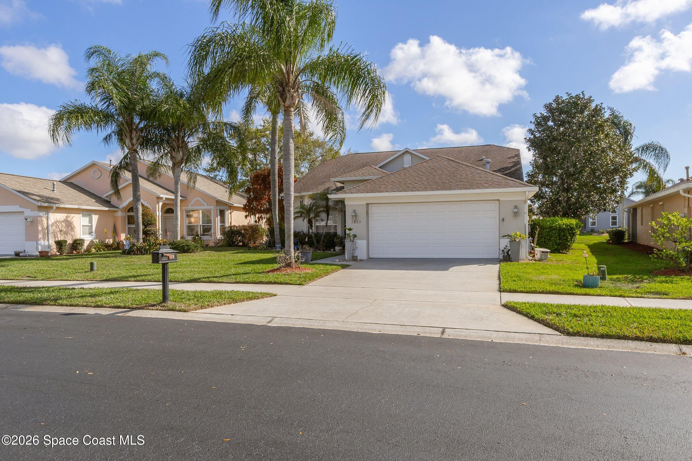 1825 Ficus Point Drive Melbourne, FL 32940 - Photo 2 of 48 a house with palm trees in front of it