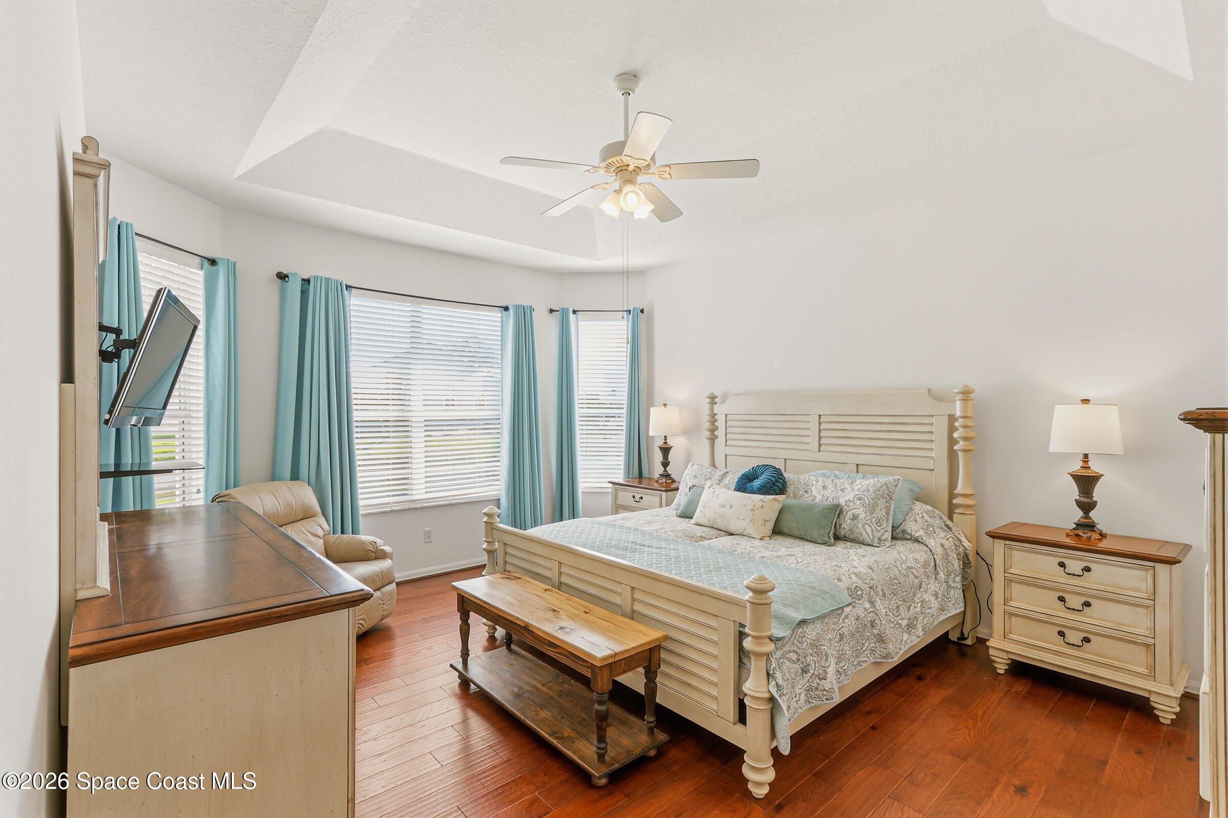 1825 Ficus Point Drive Melbourne, FL 32940 - Photo 21 of 48 a bedroom with a bed and wooden floor