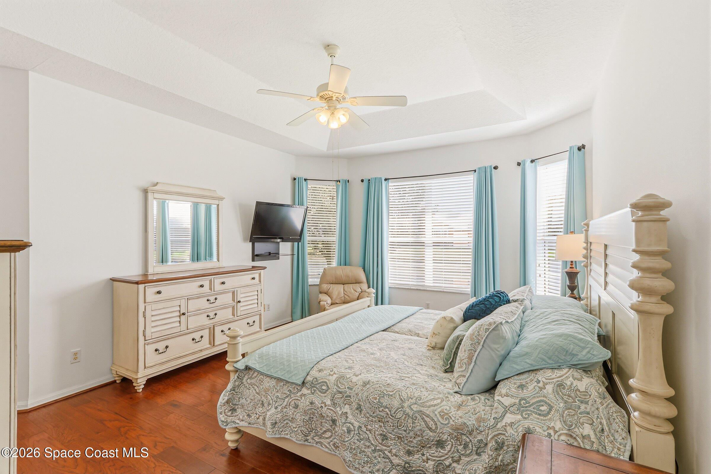 1825 Ficus Point Drive Melbourne, FL 32940 - Photo 22 of 48 a bedroom with a bed a window and dresser
