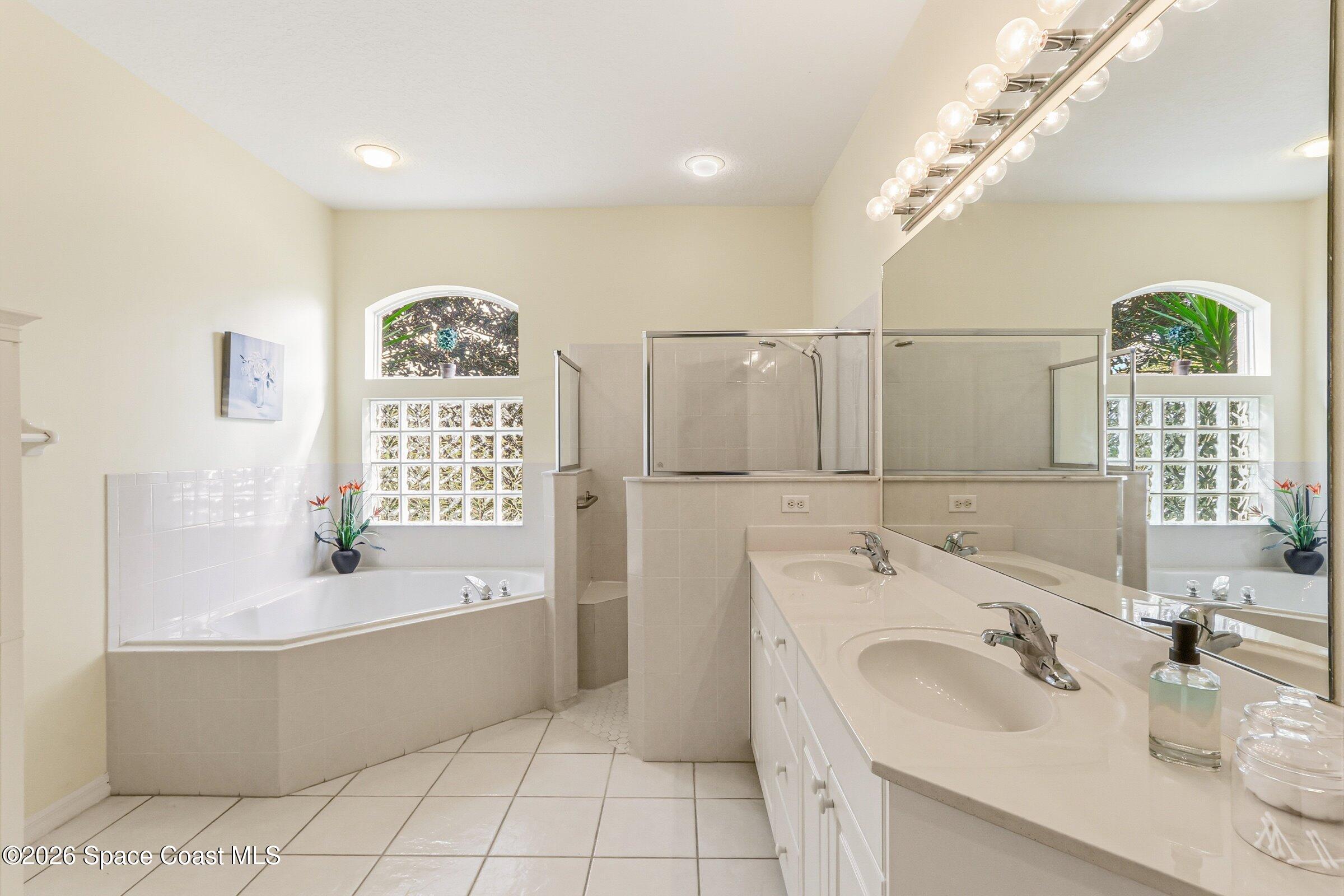 1825 Ficus Point Drive Melbourne, FL 32940 - Photo 23 of 48 a bathroom with a tub sink and mirror