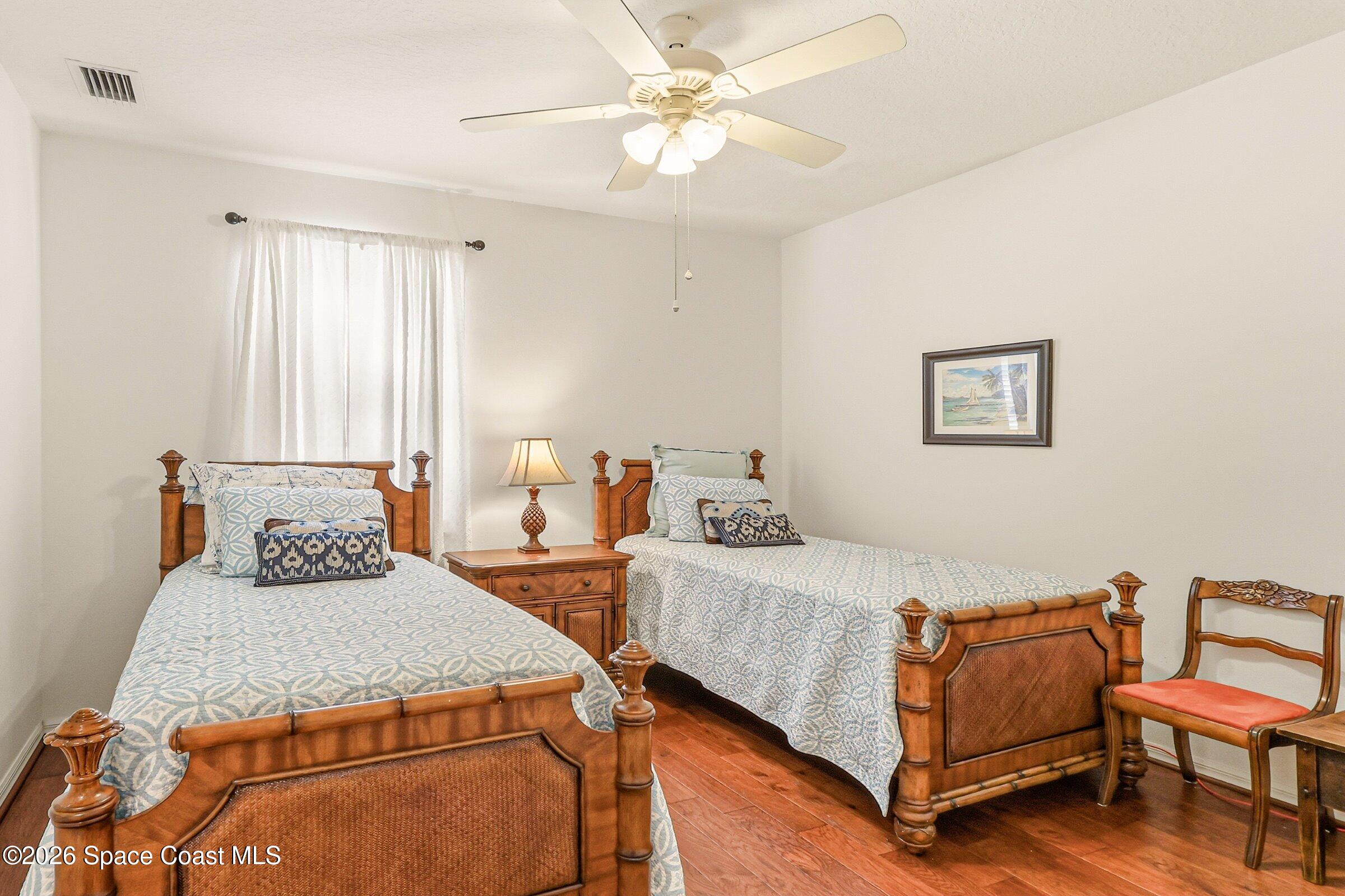 1825 Ficus Point Drive Melbourne, FL 32940 - Photo 26 of 48 a bedroom with a bed and wooden floor