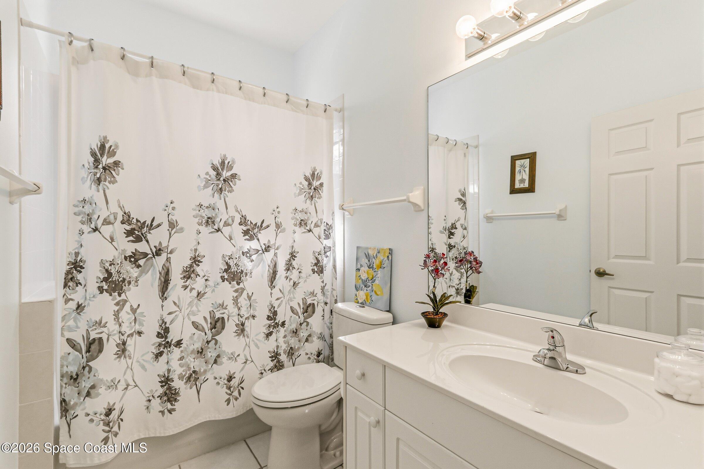 1825 Ficus Point Drive Melbourne, FL 32940 - Photo 27 of 48 a bathroom with a sink and a mirror