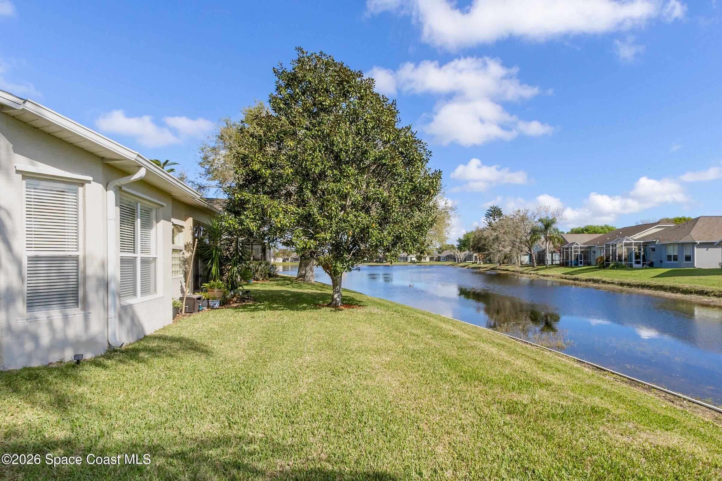 1825 Ficus Point Drive Melbourne, FL 32940 - Photo 31 of 48 a view of a house with pool and a yard